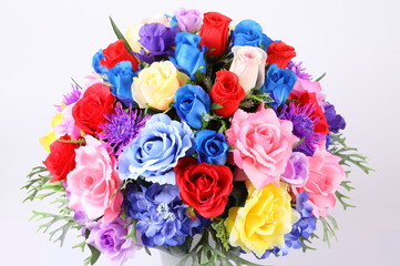 Colorful flower arrangement centerpiece in white ceramic vase