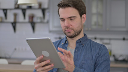 Portrait of Ambitious Beard Young Man using Tablet