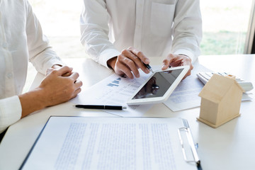 Real Estate Agent broker or House developer showing contract for buying house agreement to consultant employee.