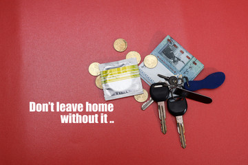 A packet of condom with banknotes and car keys.  A conceptual message on sex education