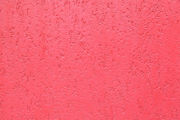 Red striated stucco wall texture