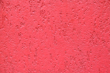 Red striated stucco wall texture