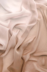 Silk fabric texture pastel beige color. Beautiful soft crumpled silk wedding background.Copy space