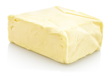 Fresh Block of Butter. Isolated on white background with shadow reflection. With clipping path. With vector path. On piece of whole butter block on white bg. On reflective underlay. With vector path.