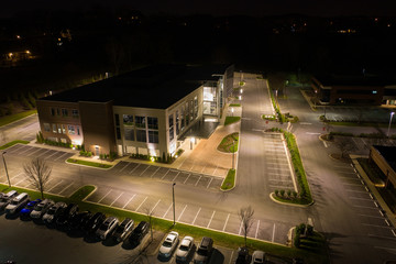 Aerial photo office building and parking lot at night