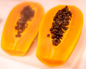 Juicy pulp with papaya seeds on the counter in the market.