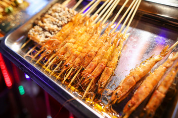 Shrimps on wooden sticks for grilling.