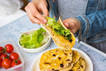 Chapati Indian flatbread. Traditional round bread. Fresh green salad and red dal lentil stuffed naan. Vegan, vegetarian healthy food. Woman hands.