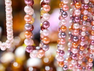 Pearl beads on a pink counter