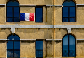 Obraz na płótnie Canvas French flag on a building facade in Marseille
