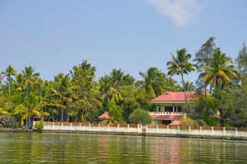 River side view with coconut tree and house in alleppey. Kerala 