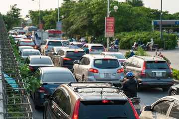 Cars on urban street in traffic jam at rush hour in big city