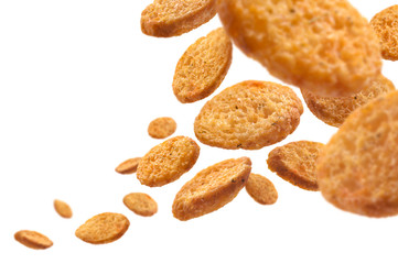 Bread croutons levitate on a white background