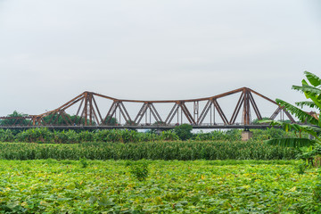 Long Bien ancient metal bridge viewing from farming field in Hanoi, Vietnam