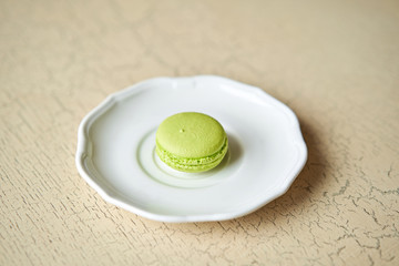 French macaroon dessert on white plate. Modern european French cuisine.