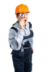 girl construction engineer examines something in a magnifying glass. Isolated
