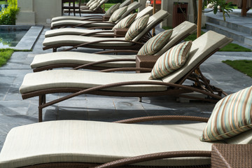 Deck chairs by the pool in resort