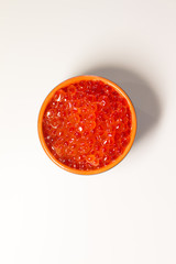 red caviar in a dish on a light table. the concept of a delicious Breakfast, buffet and snack. seafood dish. the view from the top. space for text.