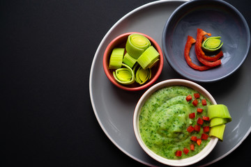 Creamy texture of green in a bowl with green vegetables spinach, broccoli and peas