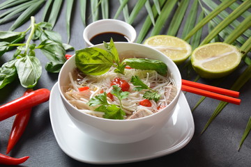 Traditional Vietnamese soup Pho bo with herbs,beef, rice noodles,chili and bean sprouts ....