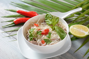 Poke bowls with fresh salmon, crystal noodles, radish, avocado, sweet pepper, cucumber, sesame seeds, red cabbage. Organic food. Fresh seafood recipe. Food concept poke bowl on wooden background