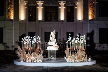photo zone with Unusual white tiered wedding cake.