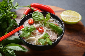 Poke bowls with fresh salmon, crystal noodles, radish, avocado, sweet pepper, cucumber, sesame seeds, red cabbage. Organic food. Fresh seafood recipe. Food concept poke bowl on wooden background