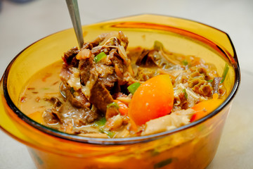 A bowl of Homemade Soto Betawi, Indonesian native traditional soup made of beef or beef offal cooked in coconut milk broth