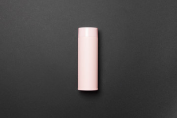 pink thermos cup on black background