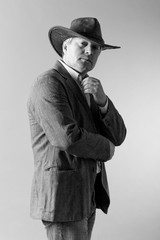 A respectable grey-haired Latino male in a hat.