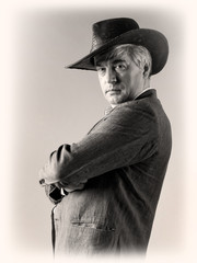 A respectable grey-haired Latino male in a hat.