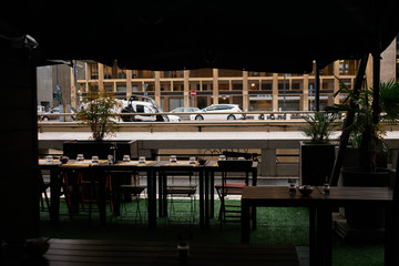 Fototapeta premium Served table in cafe with view to big city street with cars and buildings