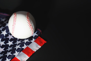 American traditional sports game. Baseball. Concept. Baseball ball and bats on a table with american flag.