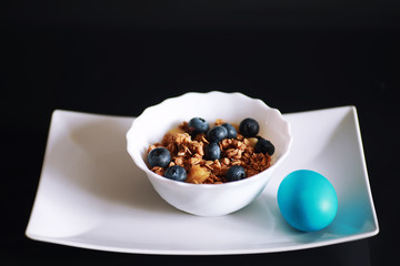 A healthy breakfast cereal with milk and fruit. Oat and corn flakes with chocolate and yogurt. The concept of healthy and vegetarian food.