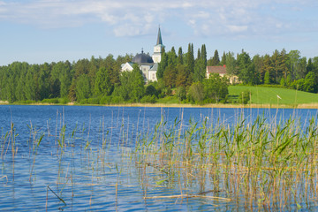 Summer landscape with an old Lutheran church. Ruokolahti, Finland