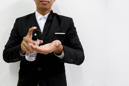 Business man clean his hands sanitizing to protect and take care of his health on white background .
