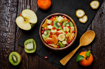Healthy fruit salad on wood background