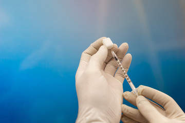Doctor picking up insulin vaccine in syringe closeup. Diabetes. Sugar as a symbol of diabetes