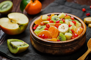 Healthy fruit salad on wood background