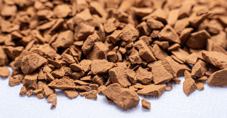 macro shot of instant coffee granules on a white background