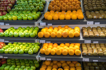 Fresh healthy fruits on shelves in supermarket