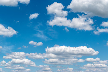 Fototapeta premium Floating white clouds on a blue sky background in summer.