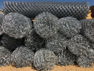 Rolled chain-link fence. Metal mesh netting rolled into rolls