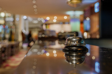 Selected focus view at Ring bell For call Service on counter   at bar in front of desk Kitchen with blur background of restaurant's atmosphere. 