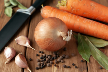 Fresh vegetables from the market for cooking vegetable broth: carrots, onions, garlic, pepper, Bay leaf. Vegetarian food