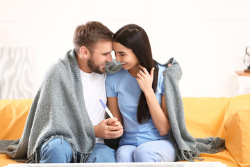 Happy young couple with pregnancy test at home