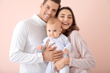 Cute baby with parents on color background