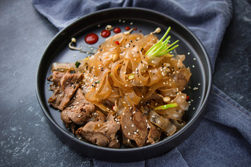 Asian Cuisine, Spicy Asian Beef Noodles on dark background
