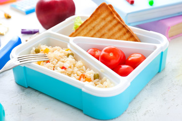 School lunch box with tasty food on table