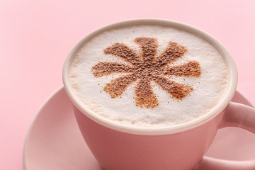 Cup of tasty cappuccino on color background, closeup